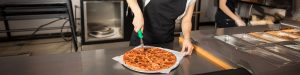 Person cutting pizza